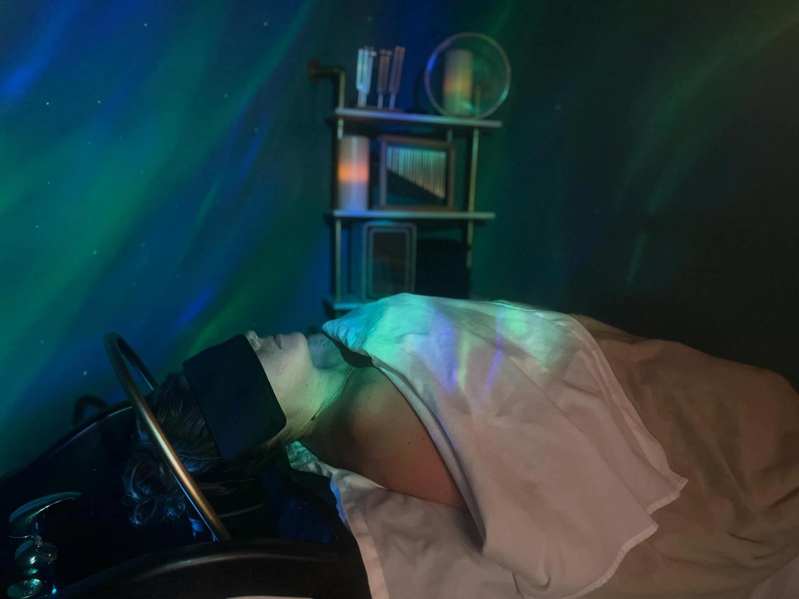 Client relaxing during luxury headspa treatment on hydrotable in a dark, peaceful room at Ideal Massage & Luxury Head Spa, Hutto TX
